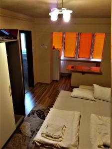 ミエルクレア・チュクにあるOxigen Lux Apartmentのベッド2台付きの部屋、オレンジ色のキャビネット付きのキッチン