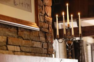a candelabra with candles in front of a stone wall at Het Ros van Twente in De Lutte +78 photos