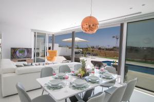 une salle à manger avec une table et des chaises blanches dans l'établissement Villa Alana, à Protaras