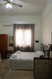 a bedroom with a large bed and a window at Bed & Breakfast Delle Palme in Trapani