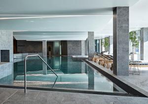 a swimming pool in a building with a pool at Steigenberger Alsik – Hotel & Spa in Sønderborg