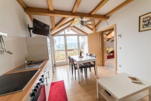 a kitchen with a table and a dining room at Lochererhof in Appiano sulla Strada del Vino