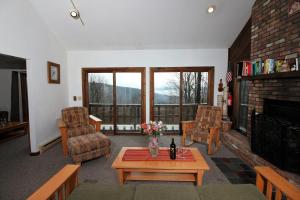 a living room with a couch and a table at Three bedroom with Beautiful View & Short Walk to the Home Stretch Trail! Frosty in Killington