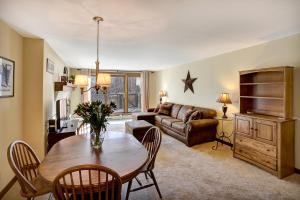 a living room with a table and a couch at Ski on ski off right from your door nicely decorated 2 bedroom, Sunrise L3 in Killington
