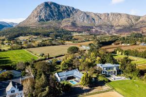 an aerial view of a home with mountains in the background at Verdun Country House in Franschhoek