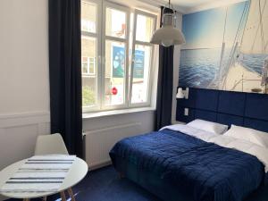 sypialnia z łóżkiem, stołem i oknem w obiekcie Pokoj Pod Żaglami w mieście Gdynia
