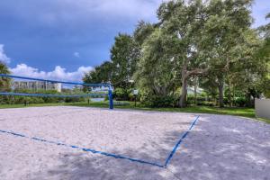 a volleyball court with a net in a park at BeachTrail Lodging in Clearwater Beach