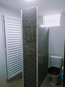 a bathroom with a toilet and a window at Lapa Casa Hostel in Rio de Janeiro