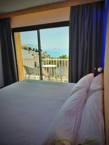 a bedroom with a bed and a view of the ocean at MB Hostels Premium ECO - Adults Recommended in Nerja