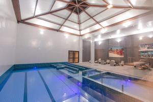 een groot zwembad met een groot plafond bij Dall'Onder Ski Hotel in Garibaldi