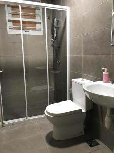a bathroom with a shower and a toilet and a sink at Fabulous Mutiara Ville Cyberjaya in Cyberjaya