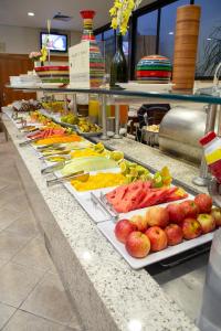 a buffet table filled with lots of different types of food at Golden Tower Pinheiros by Fênix Hotéis in São Paulo