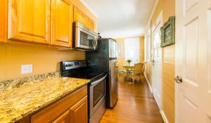 a kitchen with a stove and a counter top at Rose Lane Villas in Key West