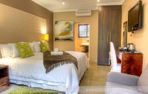 a hotel room with a bed and a television at The duBoirs Boutique Guest House in Waterfall
