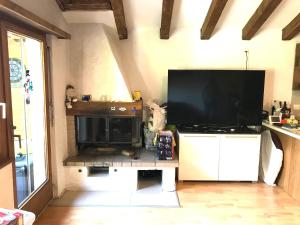 a living room with a large flat screen tv at Appartamento chalet in Laax