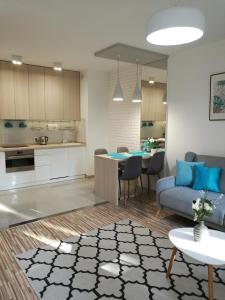 a kitchen and living room with a couch and a table at Apartament Mini in Lublin