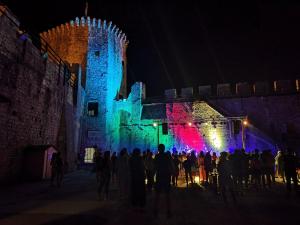 a group of people standing in front of a castle at night at Heritage Bella Vista Apartments in Trogir
