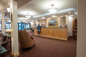 a woman is standing in a hair salon at Sophie Station Suites in Fairbanks
