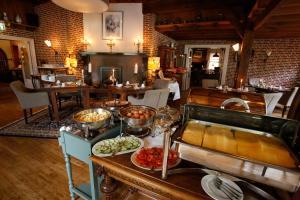 a buffet in a restaurant with food on a table at Het Ros van Twente in De Lutte