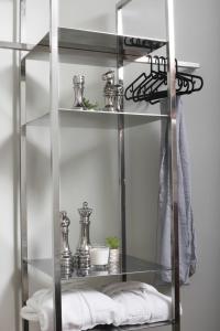 a glass shelf with silver items on it at Beddington Residence Sisli in Istanbul +48 photos
