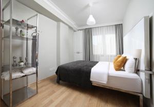 a bedroom with a bed and a glass shelf at Beddington Residence Sisli in Istanbul