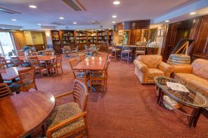een restaurant met tafels en stoelen en een bibliotheek bij Sophie Station Suites in Fairbanks