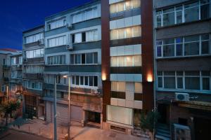 a tall building with many windows on a city street at Beddington Residence Sisli in Istanbul