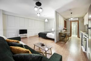 a living room with a couch and a bed at Beddington Residence Sisli in Istanbul