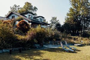 a house on a hill with a bench in the yard at Lake Villa Lotus in Luzern
