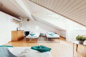 a attic room with two beds and a table at Lake Villa Lotus in Lucerne