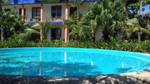 a swimming pool in front of a house at Eco Coco Loco by Rotamundos in Las Casitas