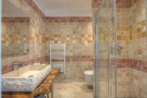 a bathroom with a sink and a toilet at U Sole Castellare in Pietracorbara +26 photos