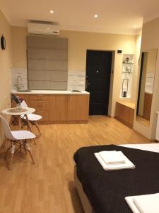 a room with a bed and a table and a kitchen at Garden Studio, Old Tbilisi in Tbilisi City