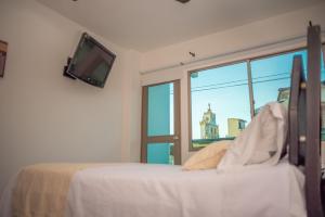 a bedroom with a bed and a window at Onoma Hotel in Lorica