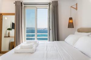 Postel nebo postele na pokoji v ubytování Obsession Mykonos