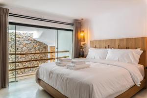 Postel nebo postele na pokoji v ubytování Obsession Mykonos