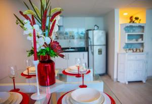 a kitchen with a table with plates and wine glasses at Casana Hotel in Cúcuta