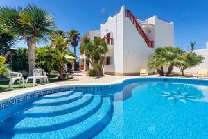 a swimming pool in front of a villa at Villa Mali in Ibiza Town