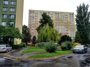 a parking lot in front of two tall buildings at Mieszkanie 2 pokoje ul. Skrzetuskiego LSM Lublin in Lublin