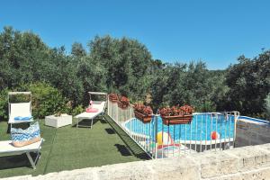 a group of chairs sitting on top of a yard at Lamia Pieranna in Cisternino