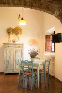 a dining room with a table and chairs and a tv at Il Melarancio Country House in Scandicci