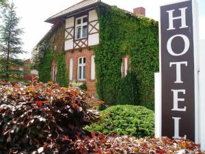 a house with a sign in front of it at Hotel Sankt Georg in Neubrandenburg