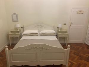 1 dormitorio con 1 cama blanca y 2 mesitas de noche en B&B Country Dreams, en Sulmona