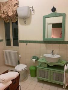a bathroom with a sink and a toilet and a mirror at B&B Country Dreams in Sulmona