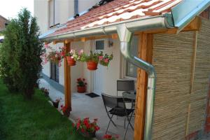 a pergola with a table and chairs on a patio at Soko S apartmani in Soko Banja