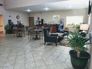 a waiting room with chairs and a table in a store at Days Inn & Suites by Wyndham Morris I-80 in Morris