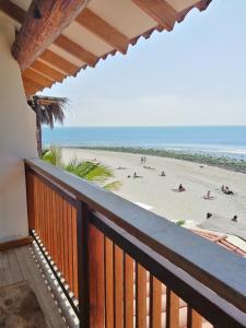 a balcony with a view of the beach at Don Giovanni Mancora in Máncora