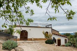 a white house with a gate and a yard at Roba Albanisi in Aragona