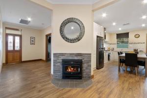a living room with a fireplace and a dining room at Williamstown Bed and Breakfast in Williamstown