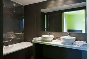 a bathroom with a sink, toilet, and counter top at Athens Center Square Hotel in Athens